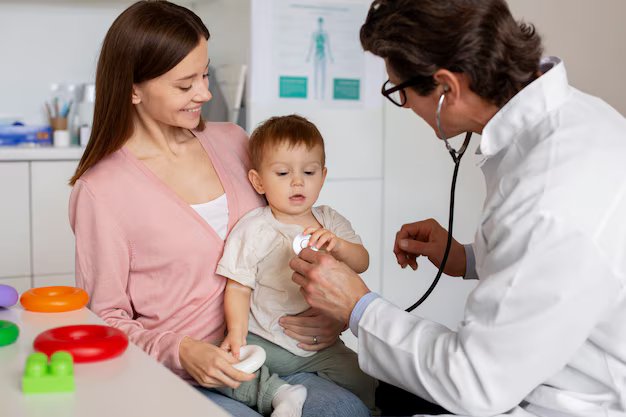 Pediatrician reviewing a toddler's vaccination record during a routine visit